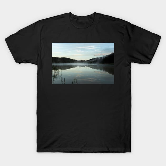 Misty Lake light blue. Amazing shot of the Ferchensee lake in Bavaria, Germany. Scenic foggy morning scenery at sunrise. T-Shirt by EviRadauscher